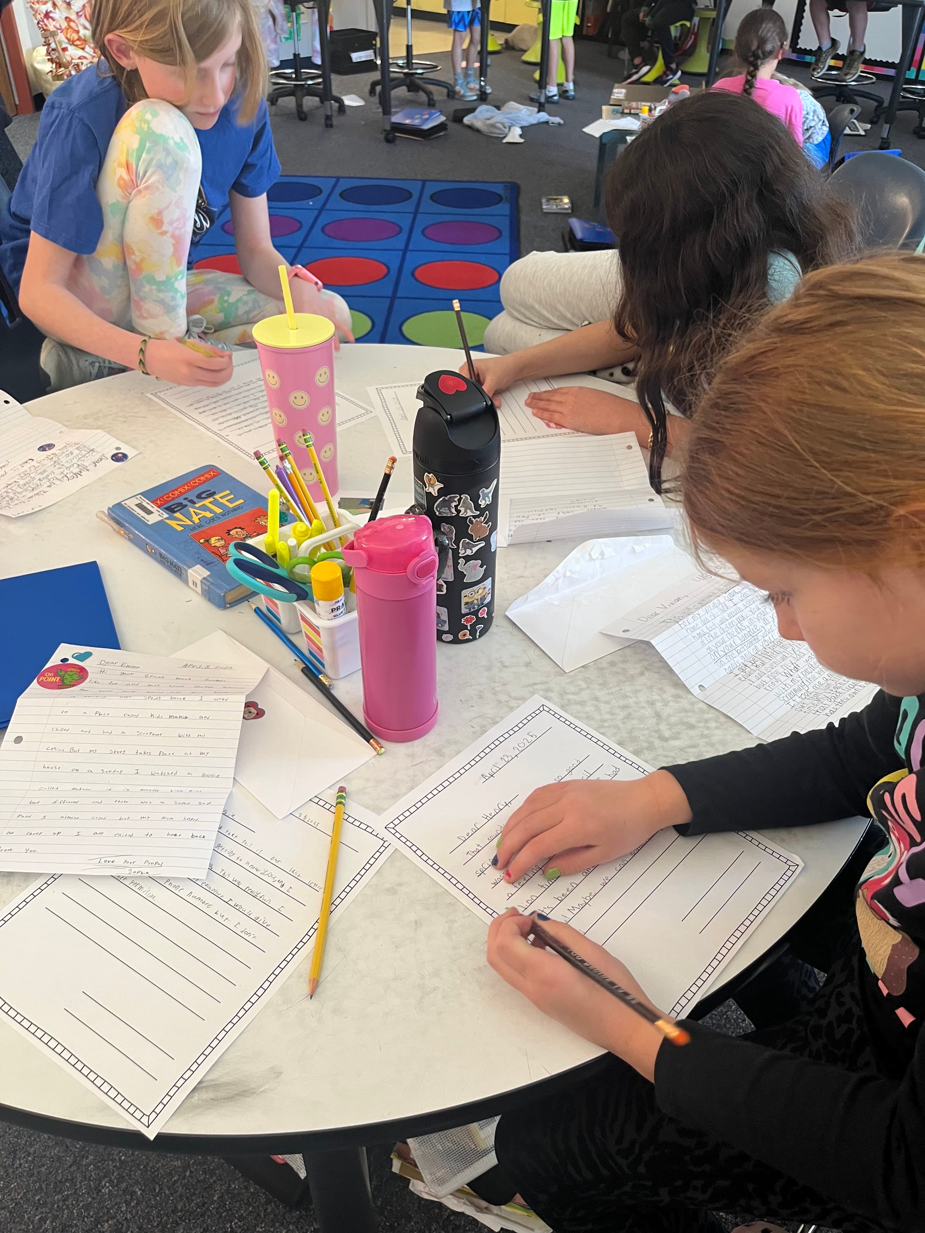 Kids writing with pencils visible
